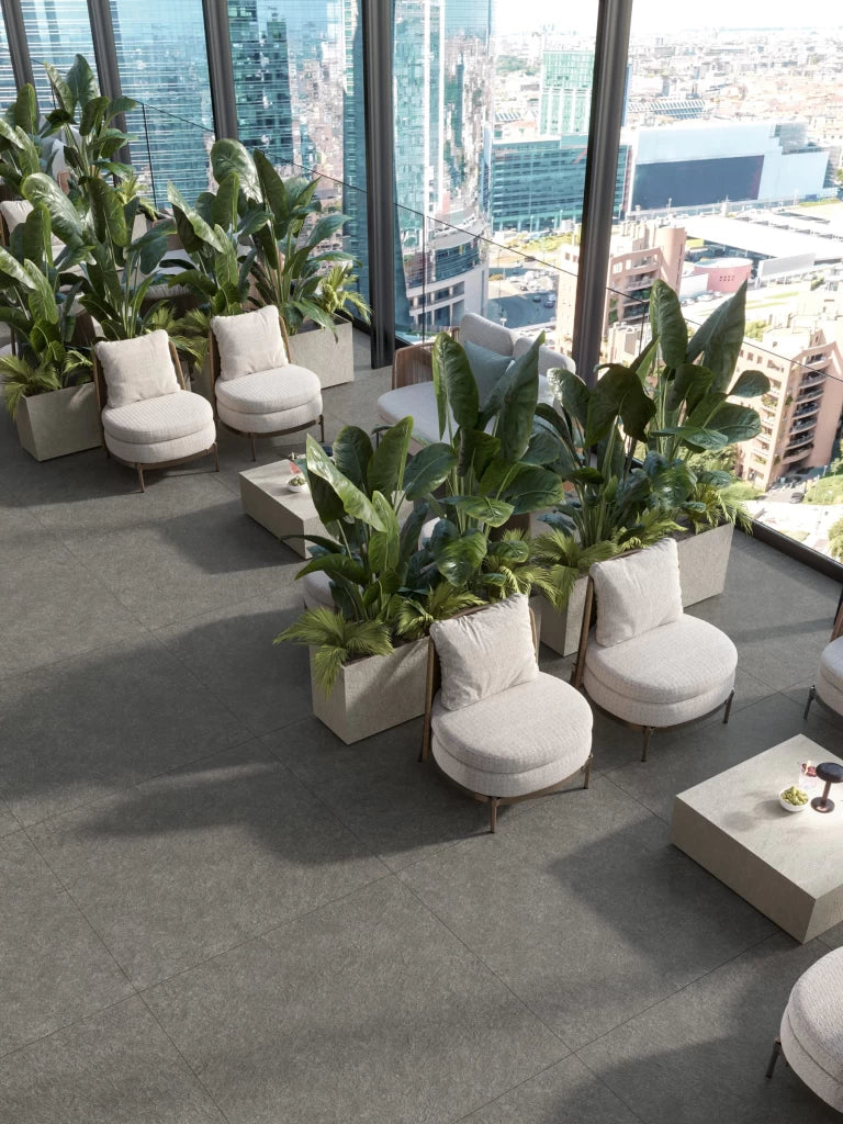Boost Mineral Grey porcelain flooring with matte finish in modern high-rise lounge — premium stone countertops installed by Signature Stone Las Vegas
