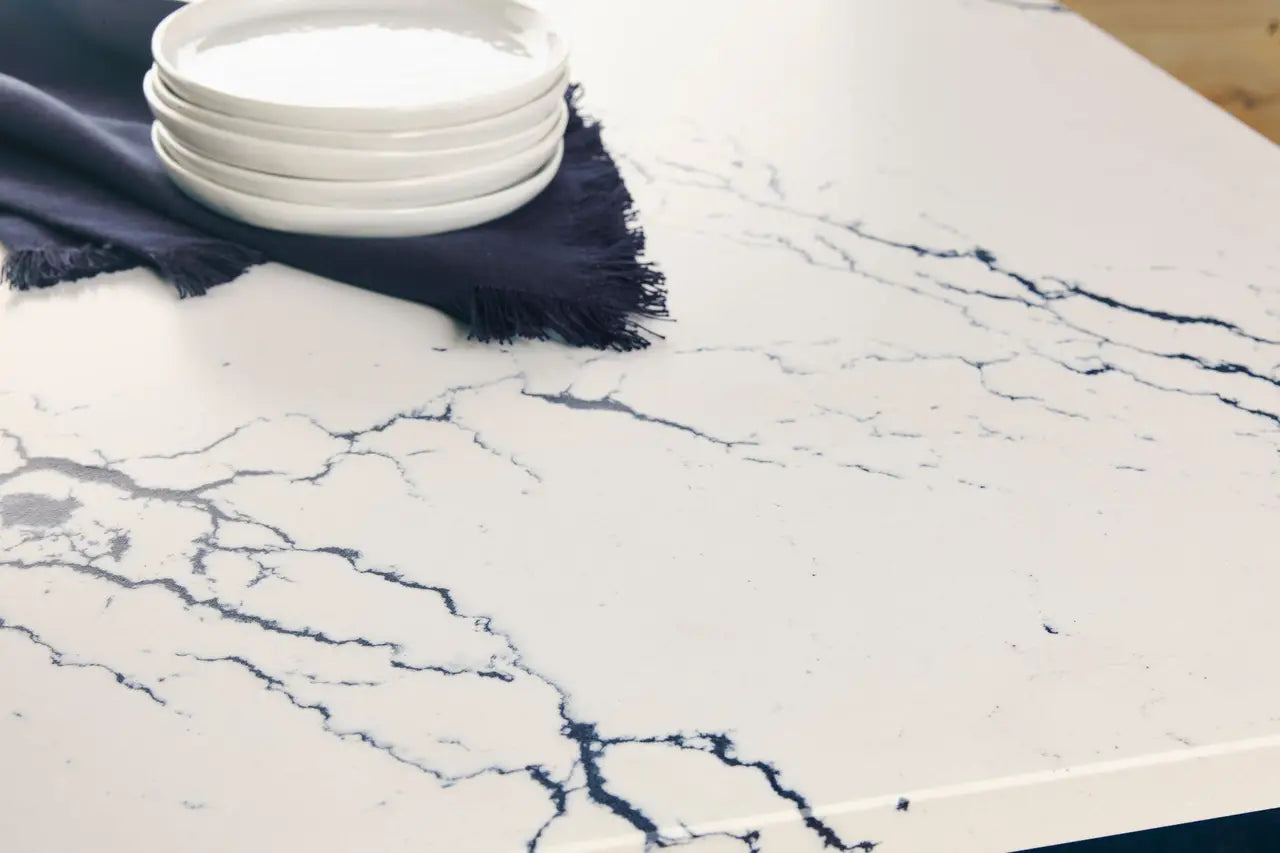 Inverness Cobalt quartz slab with white base and bold blue veining — custom countertops fabricated and installed by Signature Stone LV