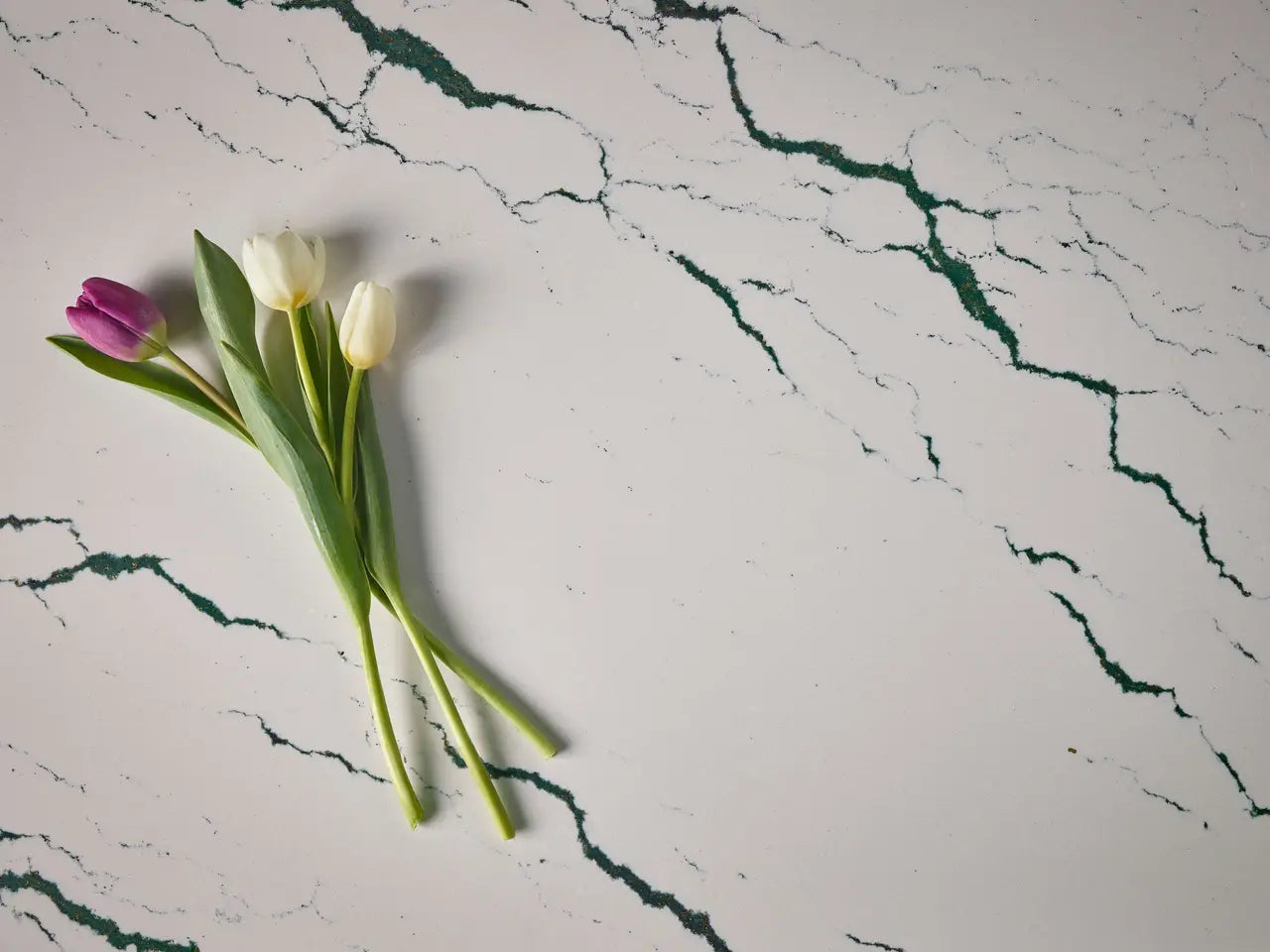 Ivybridge quartz surface with white base and green veining pattern — elegant custom countertops fabricated and installed by Signature Stone LV