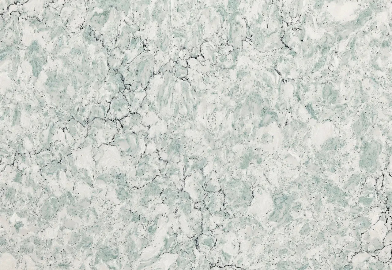 Marble surface with light green and white veining pattern and natural cracks — premium countertop fabrication by Signature Stone Las Vegas