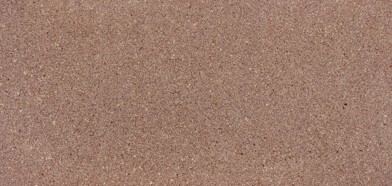 Quartz slab surface with warm beige speckled finish and subtle brown flecks — premium stone countertops installed by Signature Stone Las Vegas