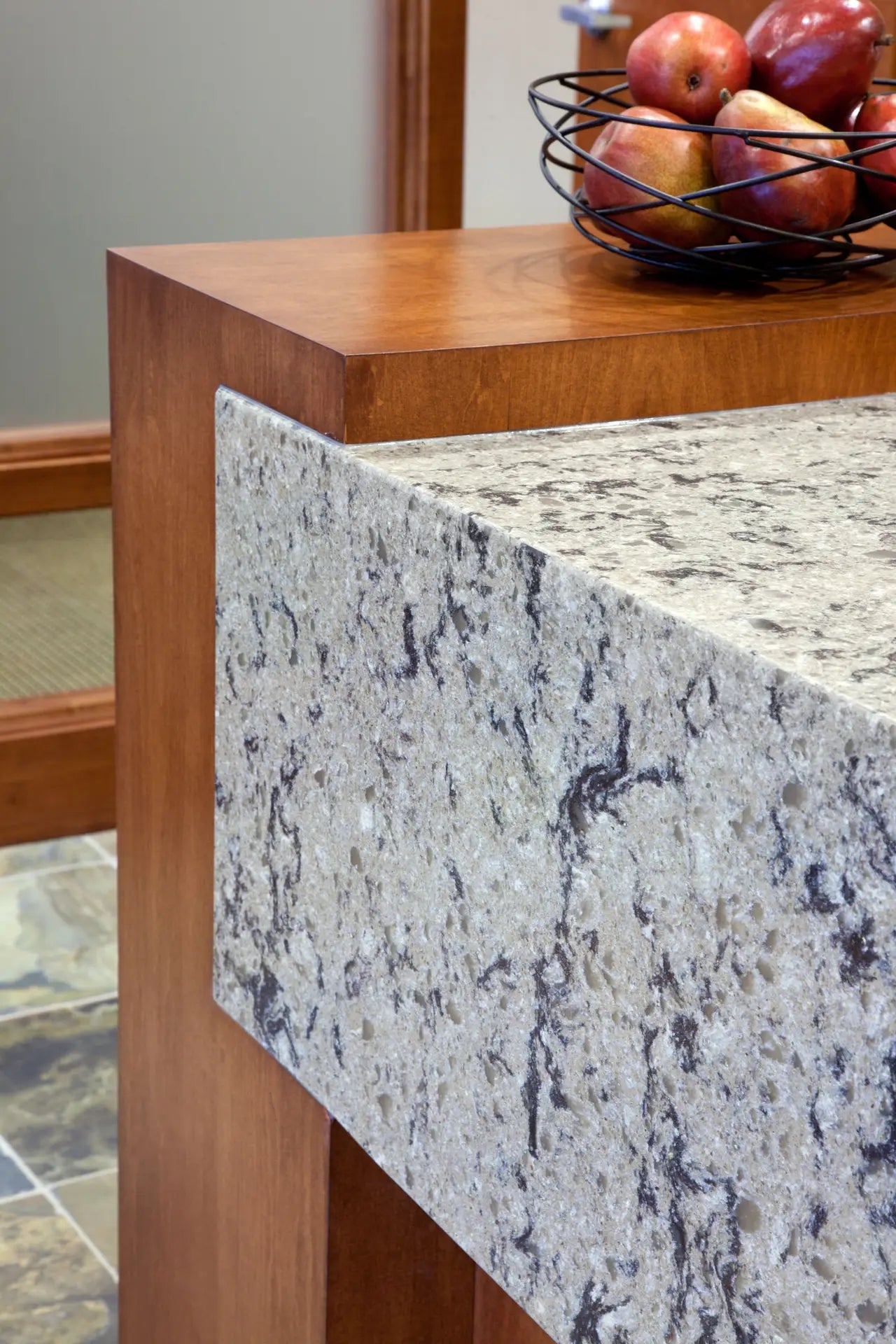 Granite kitchen island with white and gray veining and wood trim detail — expert countertop fabrication by Signature Stone Las Vegas