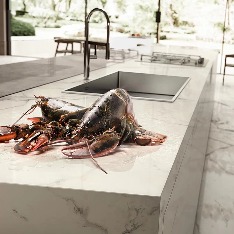 Calacatta Extra marble kitchen island with white veining and square undermount sink — custom countertops fabricated and installed by Signature Stone LV