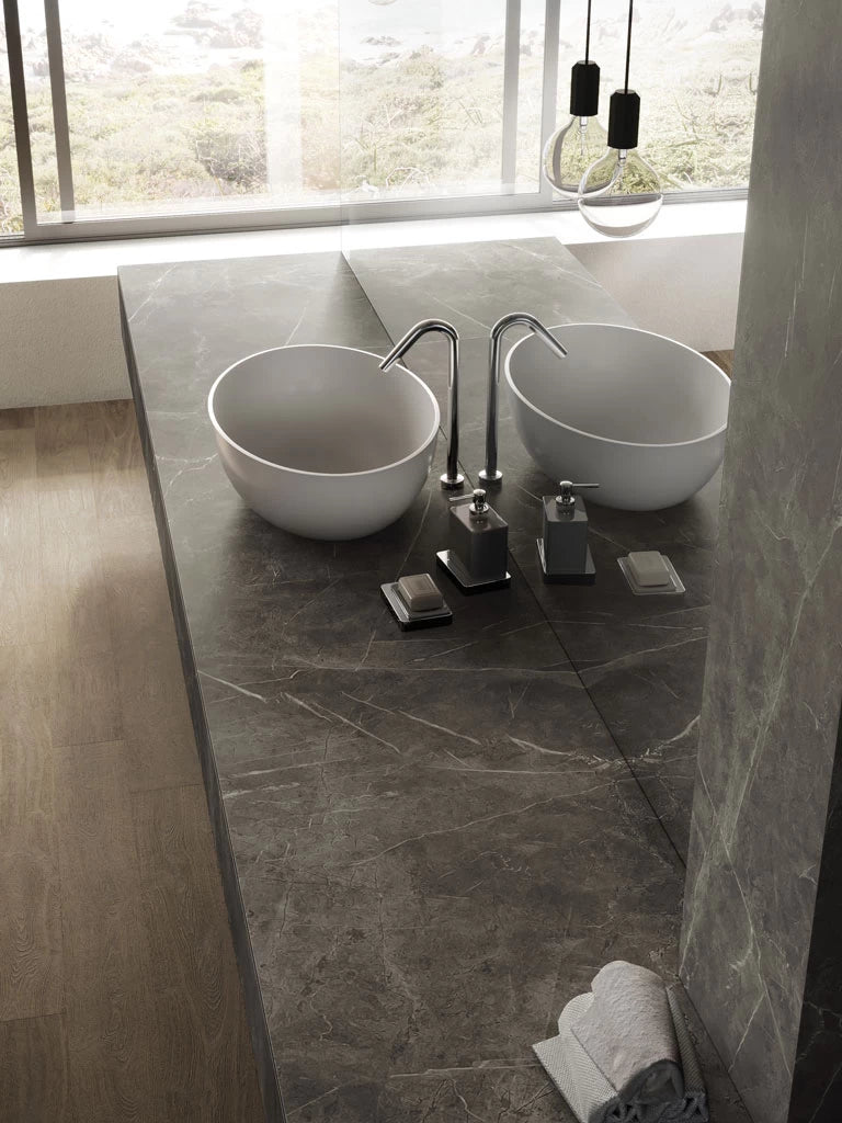 Grey stone bathroom vanity with honed finish and modern vessel sinks — custom countertops fabricated and installed by Signature Stone LV