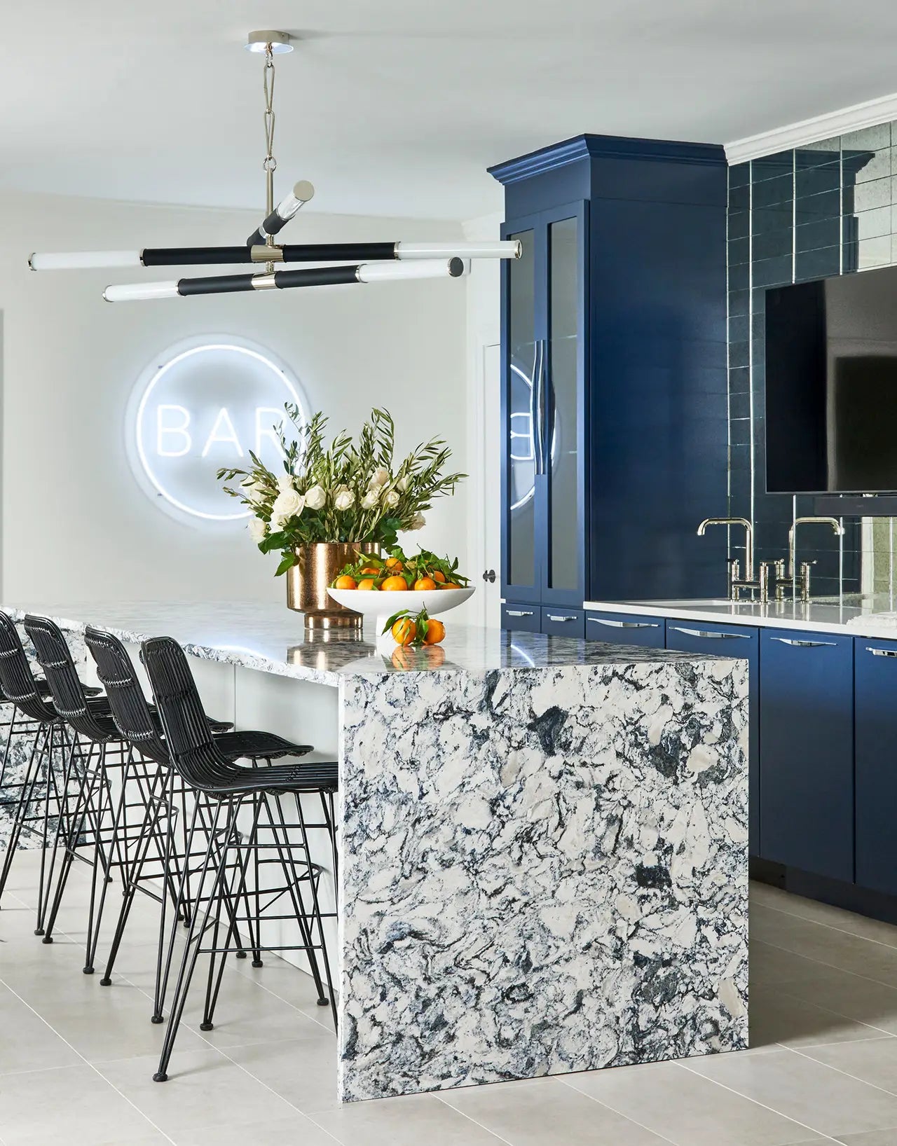 Quartz kitchen island with dramatic white and gray veining and waterfall edge — premium stone countertops installed by Signature Stone Las Vegas