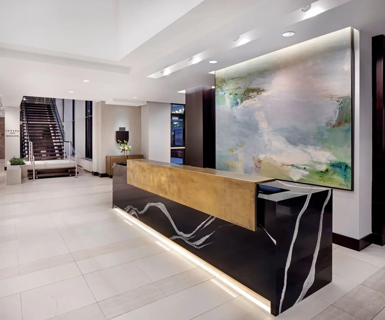 Marble reception desk with dramatic black veining and gold accents in modern lobby — premium stone countertops installed by Signature Stone Las Vegas