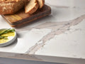 Nadenbrook quartz kitchen countertop with white marble veining and polished finish — elegant stone countertops installed by Signature Stone Las Vegas