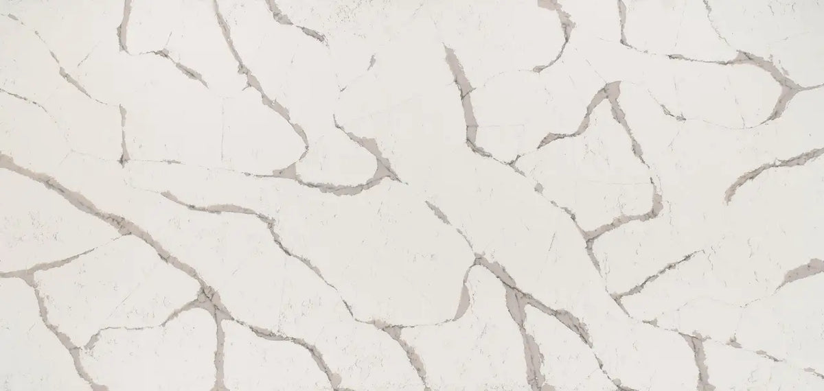 Quartz surface with light cream background and gray veining pattern — custom countertops fabricated and installed by Signature Stone LV