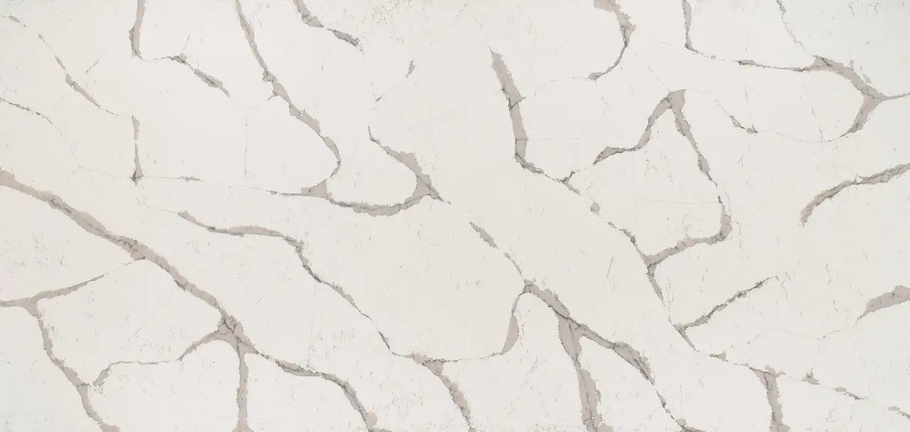 Quartz surface with light cream background and gray veining pattern — custom countertops fabricated and installed by Signature Stone LV