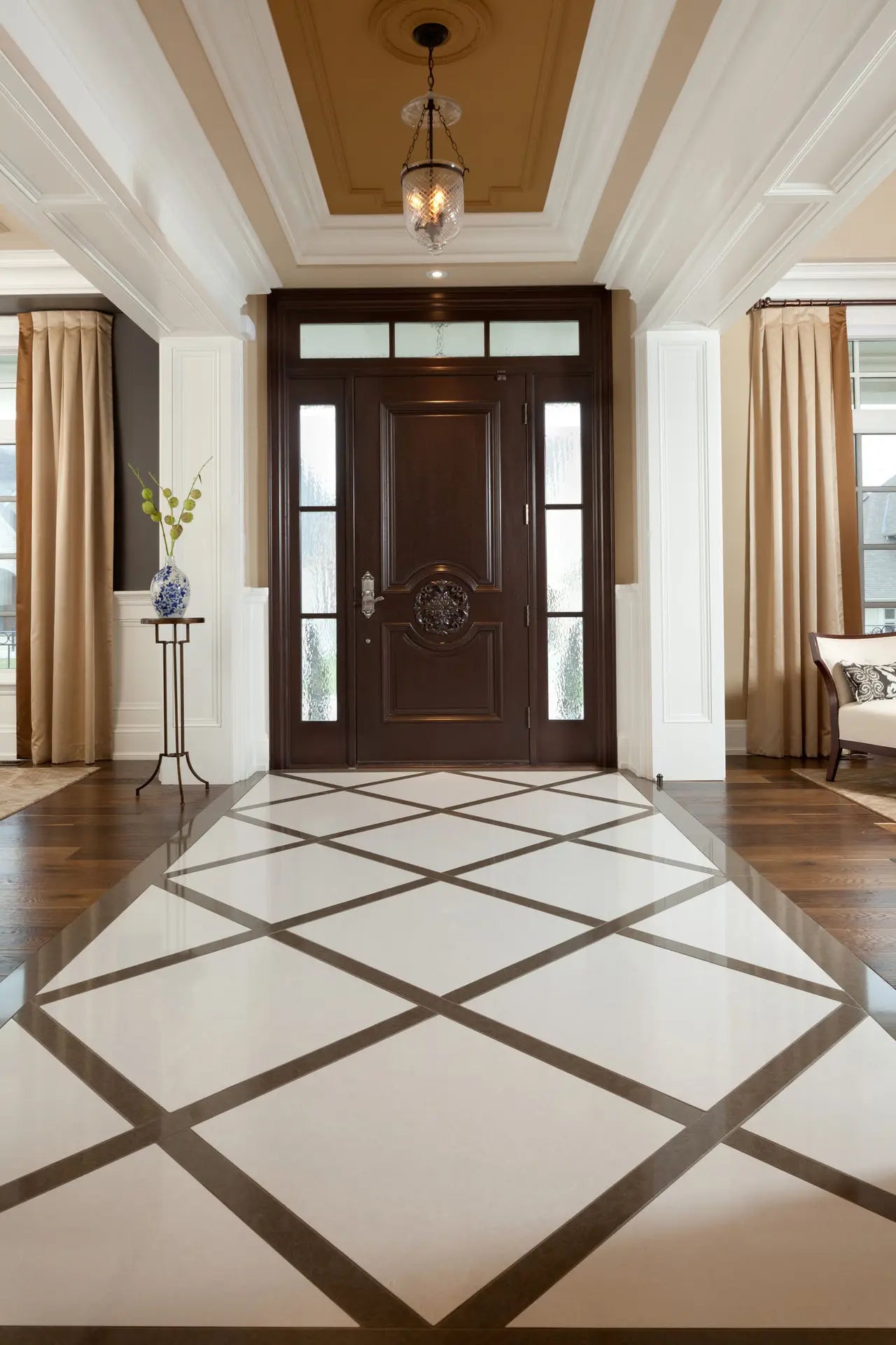 Marble entryway flooring with diamond pattern inlay and dark bronze trim — elegant stone countertops installed by Signature Stone Las Vegas