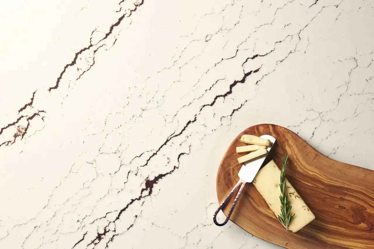 Marble surface with white base and dark brown veining featuring cheese board display — premium countertop fabrication by Signature Stone Las Vegas