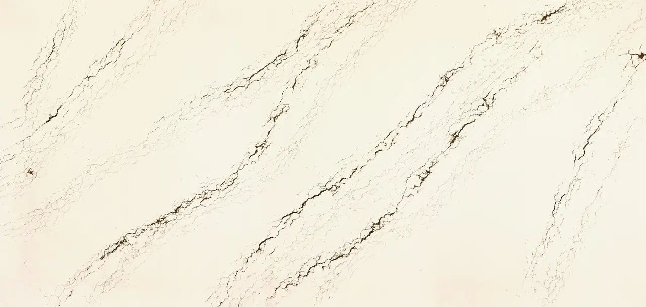 Quartz slab surface with cream base and diagonal brown veining pattern — custom countertops fabricated and installed by Signature Stone LV