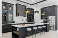 Calacatta quartz kitchen island and perimeter countertops with white marble veining and polished finish — elegant stone countertops installed by Signature St...