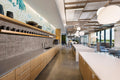Pikes Peak quartz kitchen island and perimeter countertops with light gray finish and straight edges — premium stone countertops installed by Signature Stone...