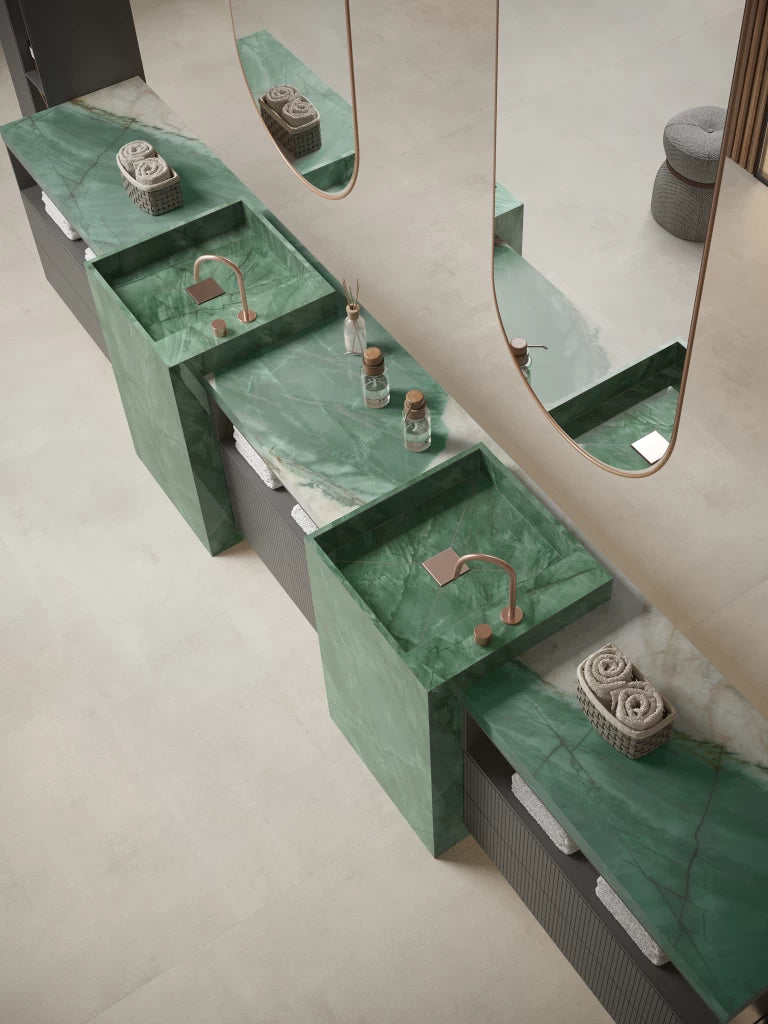 Exotic green marble vanity countertops with integrated sinks and copper faucets — luxury stone countertops installed by Signature Stone Las Vegas