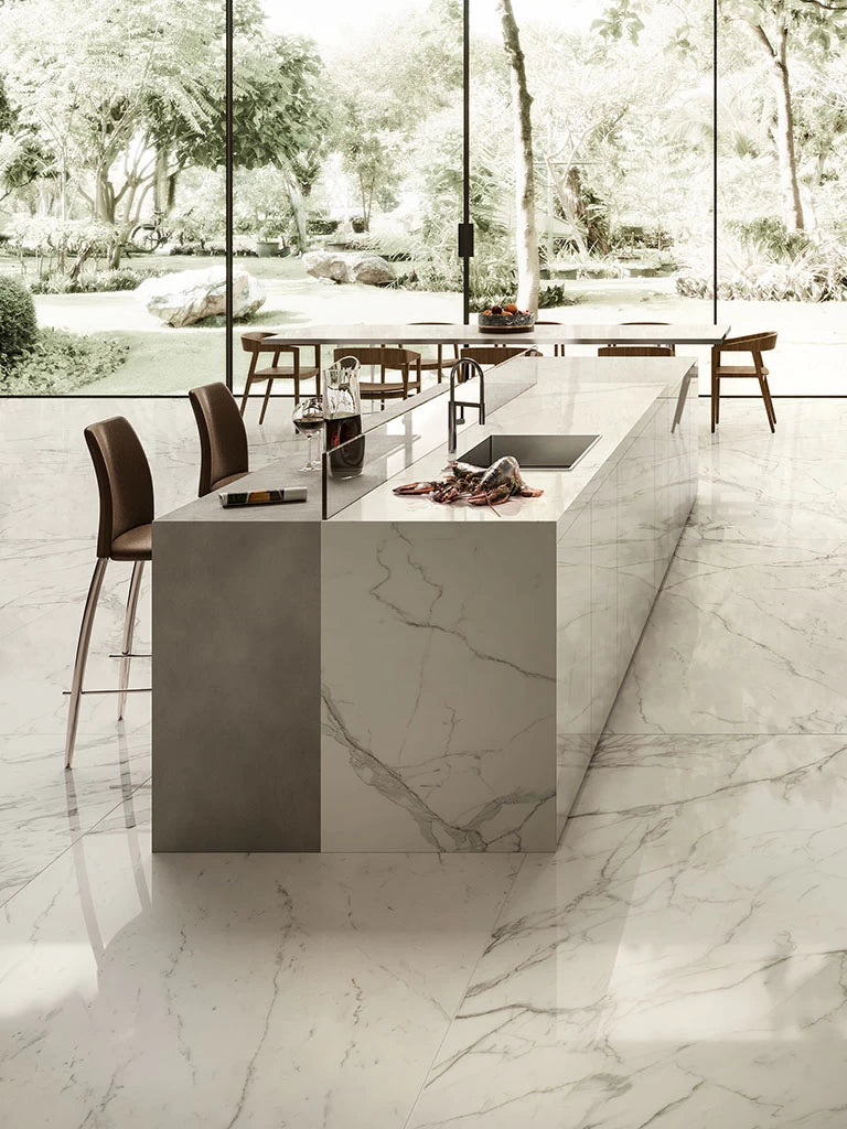 Calacatta Extra kitchen island with white marble veining and waterfall edge — elegant stone countertops installed by Signature Stone Las Vegas