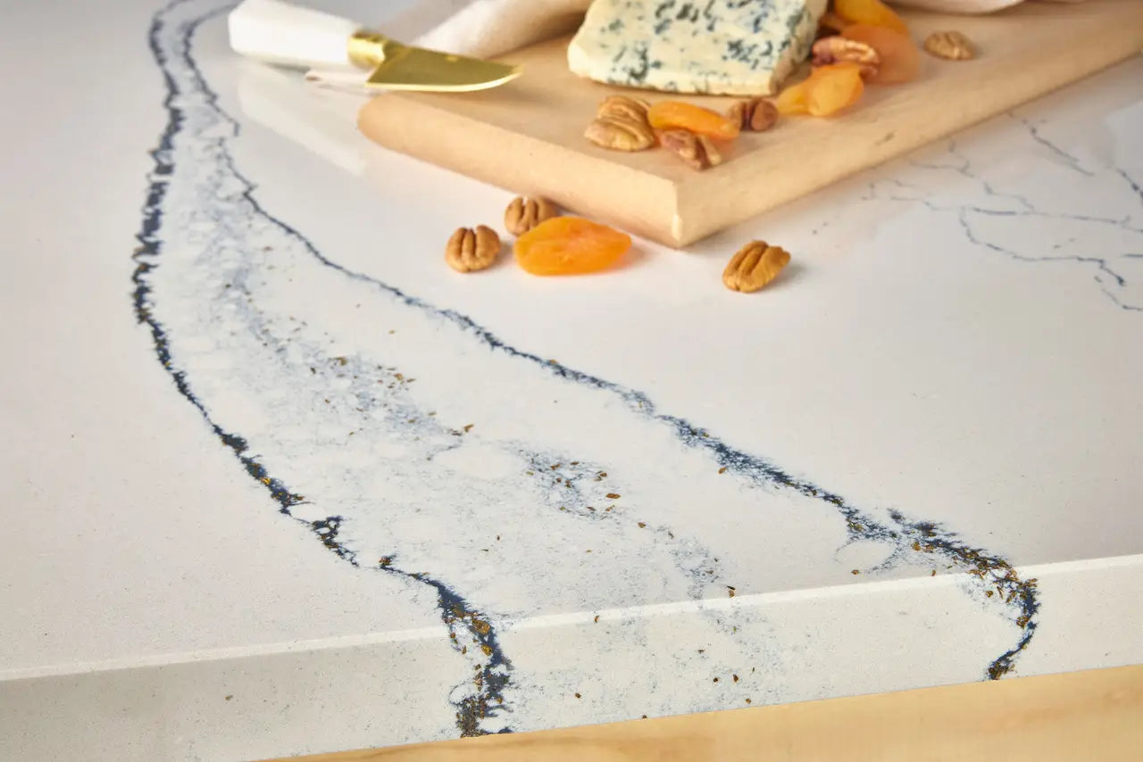 Marble kitchen countertop with dramatic white and gray veining displayed with cheese board — custom countertops fabricated and installed by Signature Stone LV