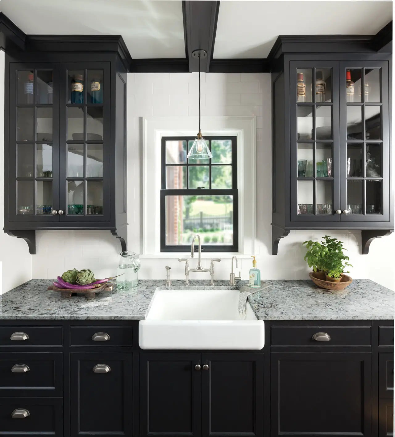 Praa Sands granite kitchen countertops with gray veining and polished finish around farmhouse sink — elegant stone countertops installed by Signature Stone L...