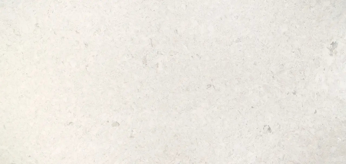 Risegate quartz surface with light cream background and subtle speckled pattern — premium countertop fabrication by Signature Stone Las Vegas