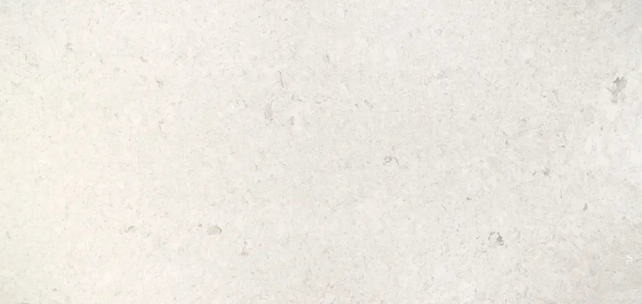 Risegate quartz surface with light cream background and subtle speckled pattern — premium countertop fabrication by Signature Stone Las Vegas