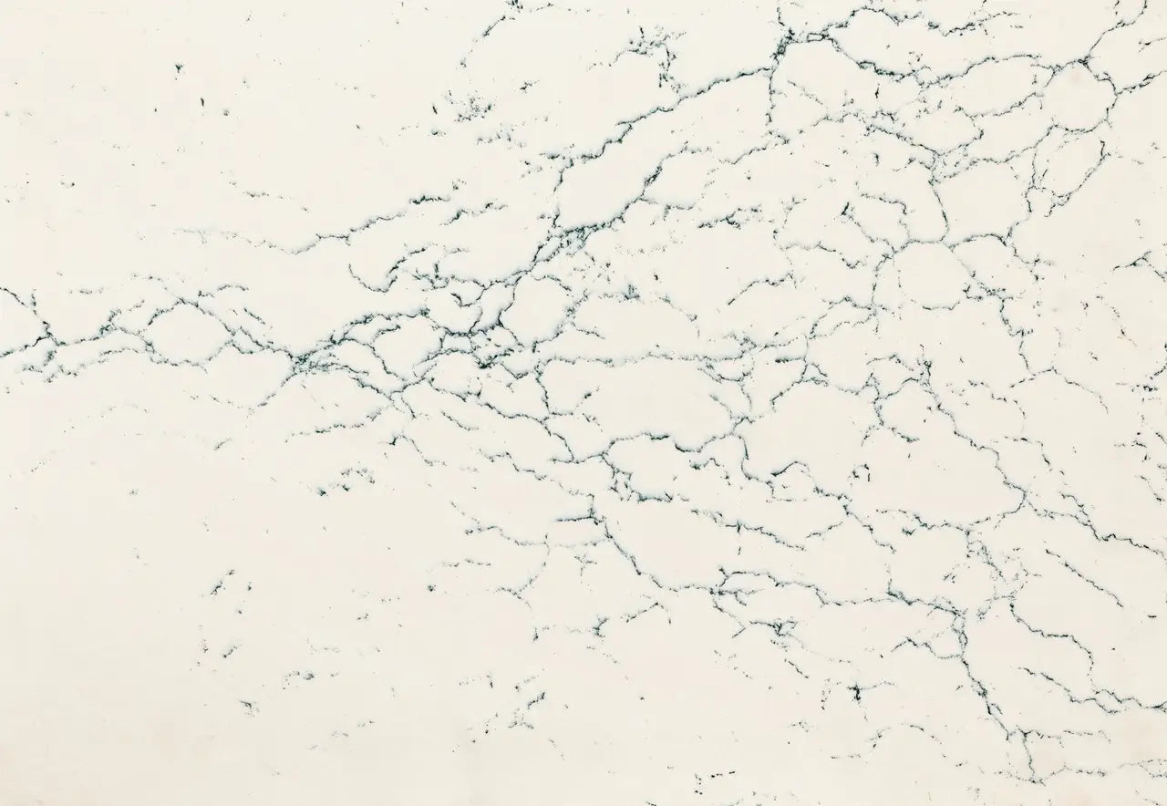 Quartz slab surface with cream base and delicate gray veining pattern — premium countertop fabrication by Signature Stone Las Vegas