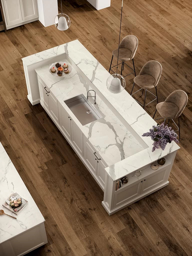 Statuario Supremo kitchen island with dramatic white marble veining and integrated sink — custom countertops fabricated and installed by Signature Stone LV
