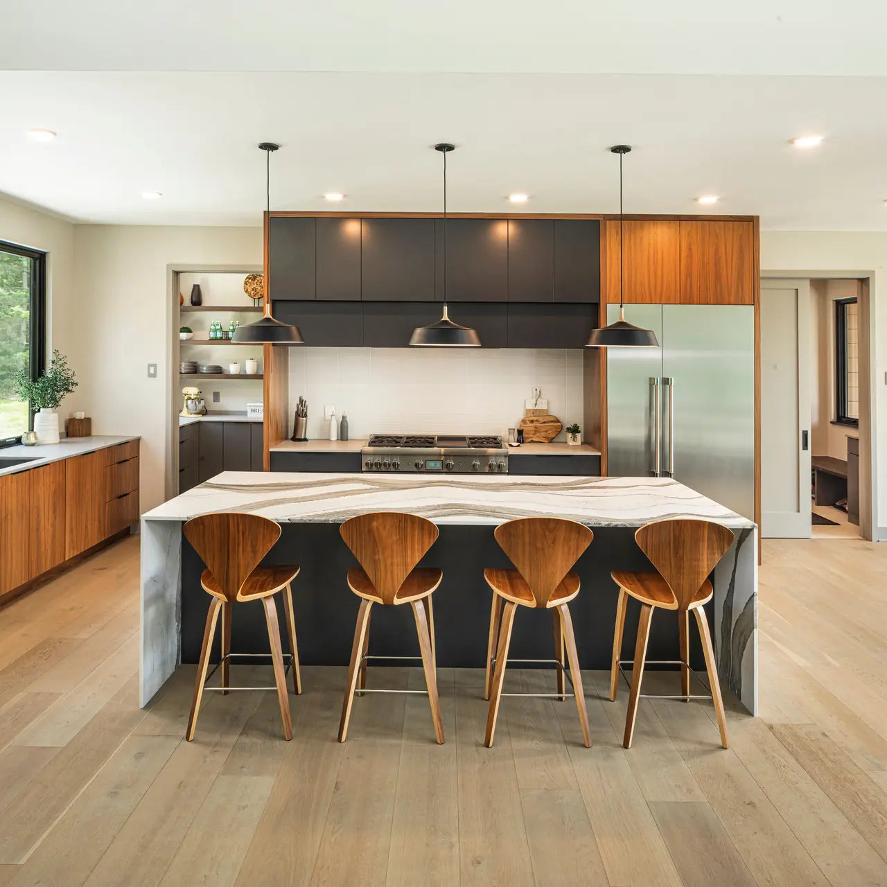 Skara Brae quartz kitchen island with dramatic veining and waterfall edge — expert countertop fabrication by Signature Stone Las Vegas