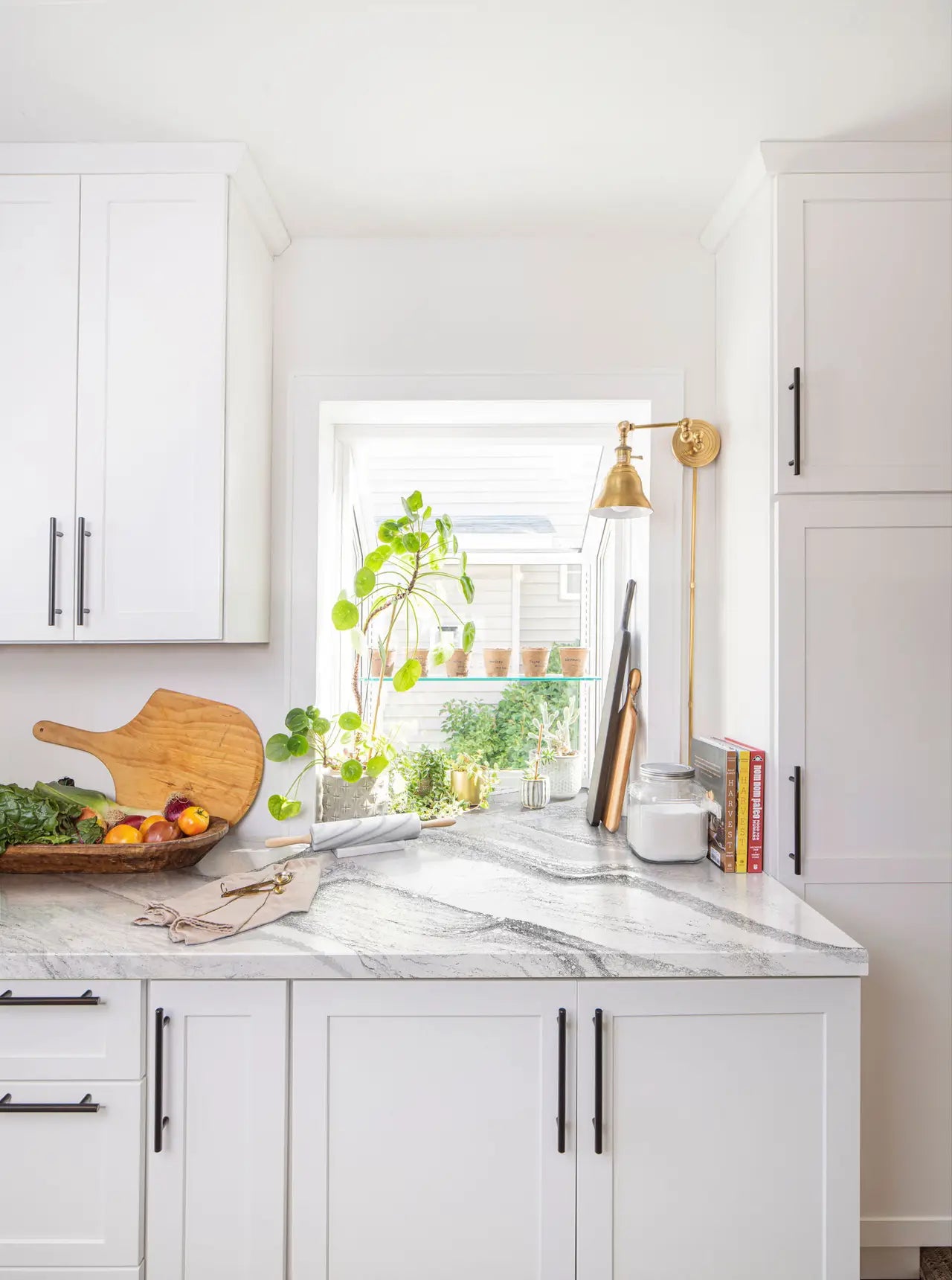Quartz kitchen countertops with white and gray veining in modern white cabinetry — custom countertops fabricated and installed by Signature Stone LV