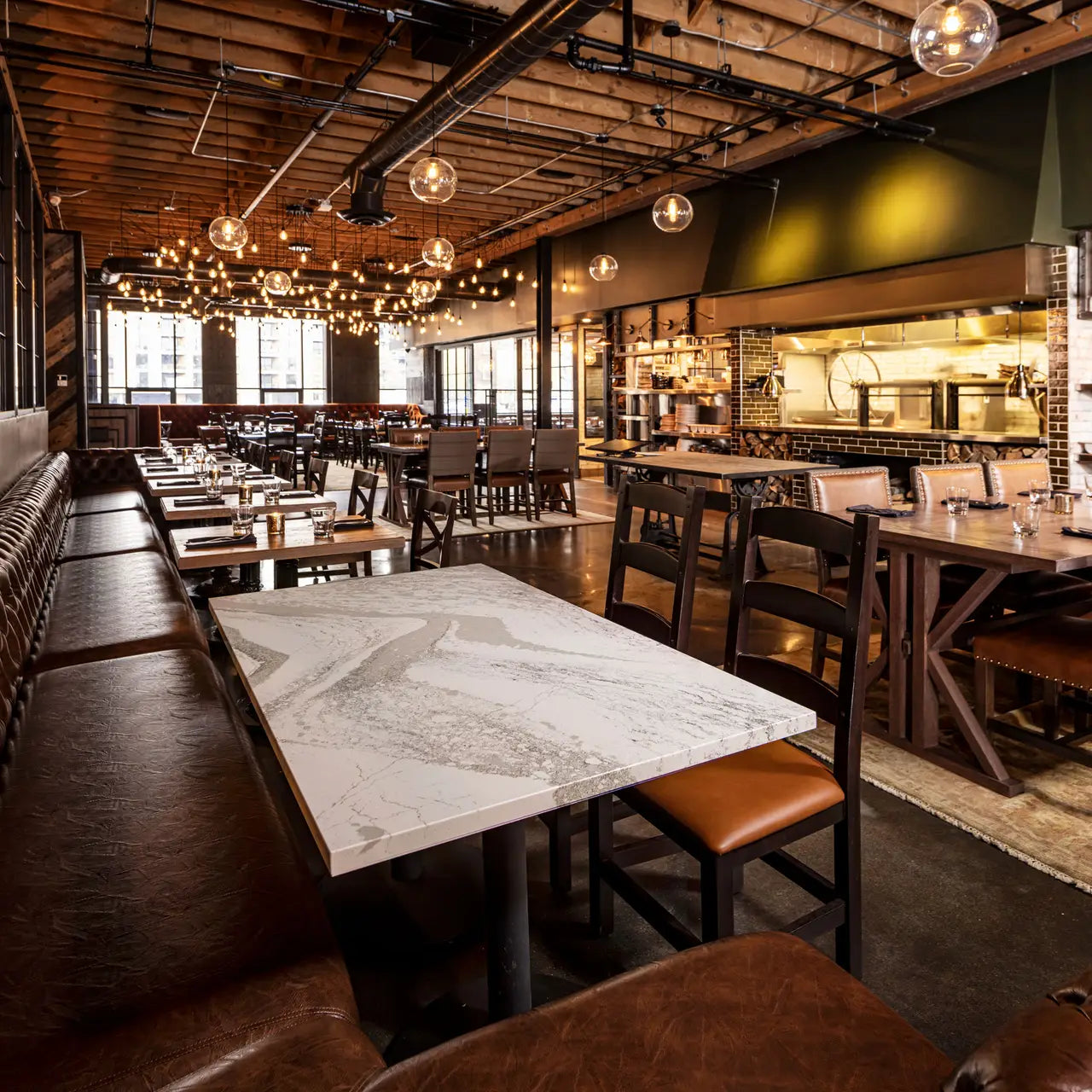 Quartz restaurant tables with white marble-look veining and polished finish — premium stone countertops installed by Signature Stone Las Vegas
