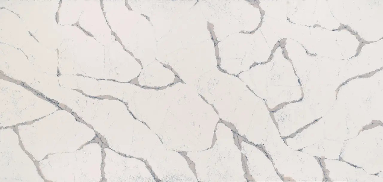 Quartz surface with soft white background and gray veining in organic flowing patterns — custom countertops fabricated and installed by Signature Stone LV