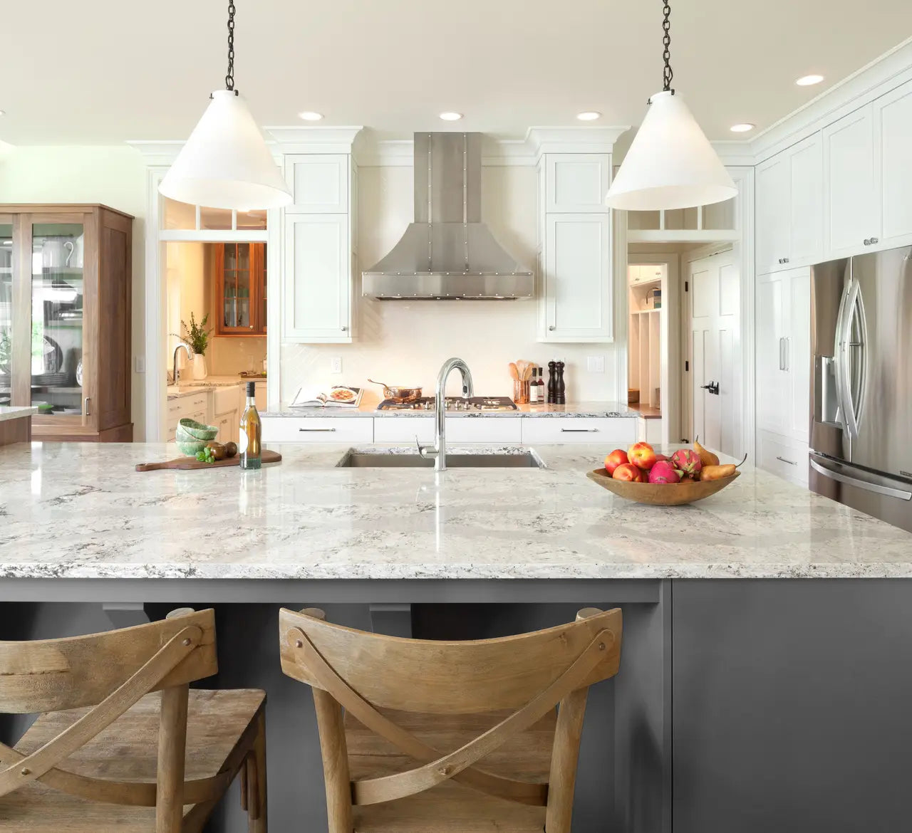 Quartz kitchen island with white veined marble-look finish and polished surface — premium stone countertops installed by Signature Stone Las Vegas