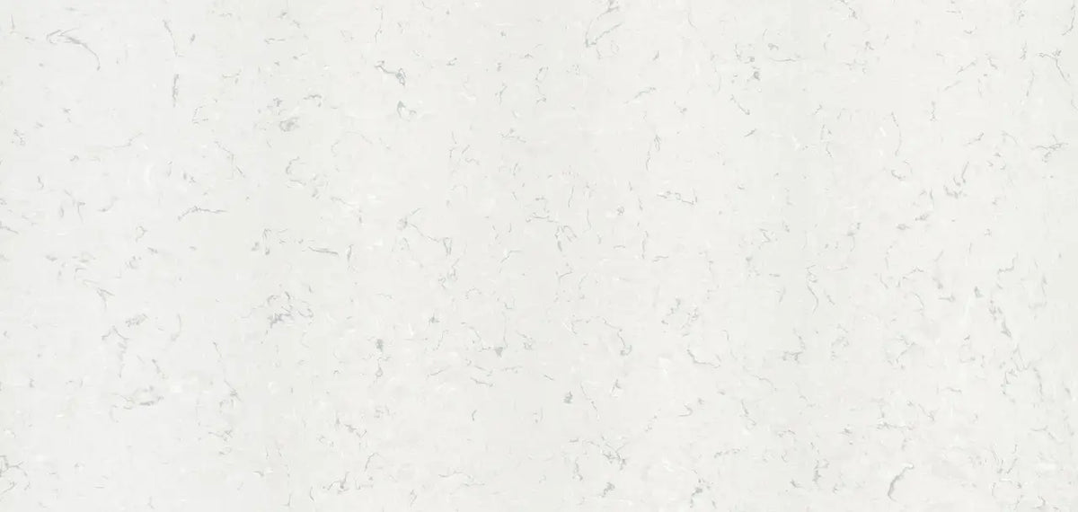 Quartz surface with light cream background and subtle gray veining throughout — premium countertop fabrication by Signature Stone Las Vegas