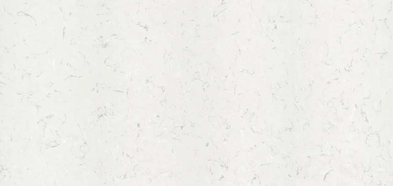 Quartz surface with light cream background and subtle gray veining throughout — premium countertop fabrication by Signature Stone Las Vegas