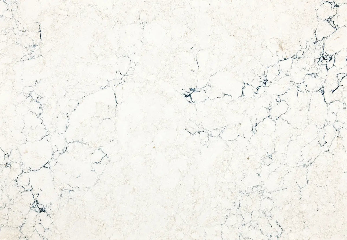 Travella quartz surface with cream base and dark blue veining — custom countertops fabricated and installed by Signature Stone LV