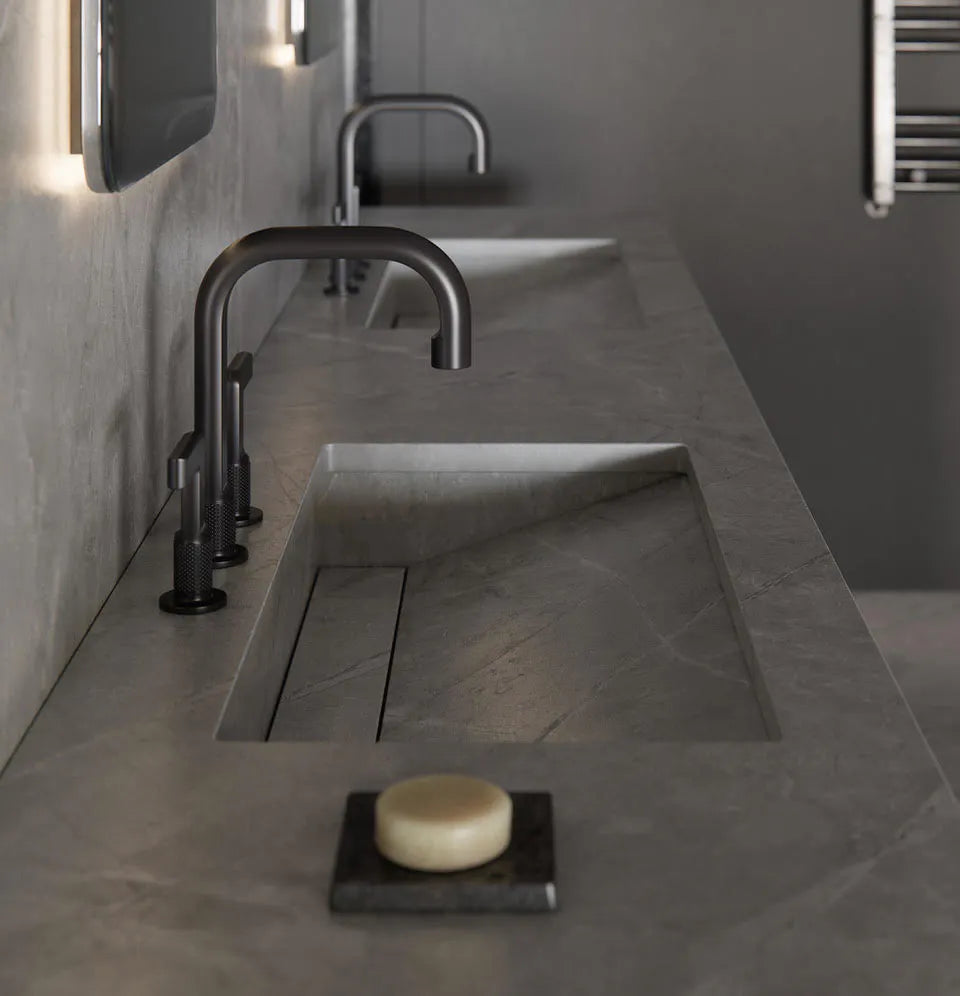 Dekton bathroom vanity with integrated sink featuring gray matte finish and modern black faucet — dekton countertops installed by Signature Stone Las Vegas
