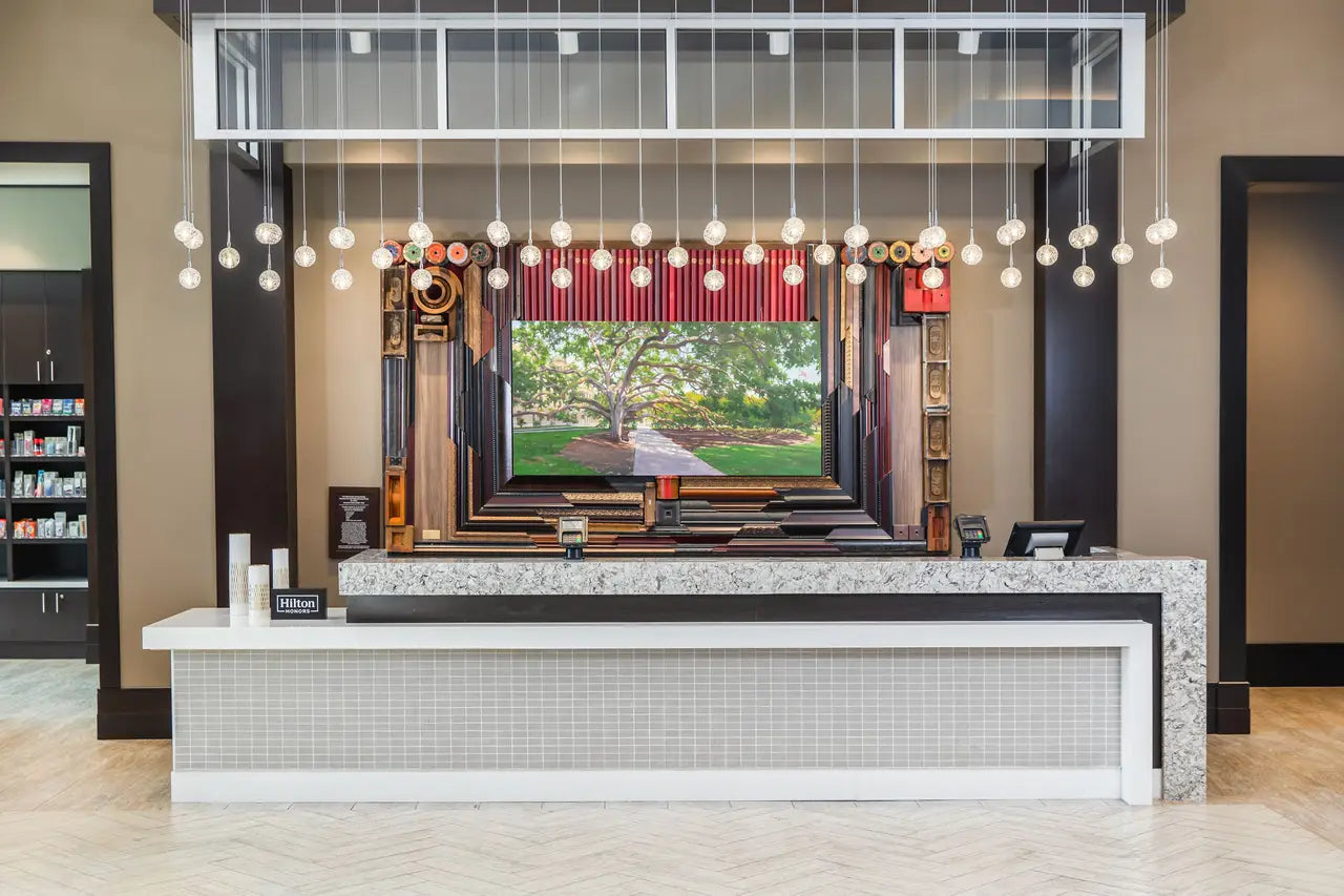 White Cliff stone reception desk with polished finish and waterfall edge — premium stone countertops installed by Signature Stone Las Vegas