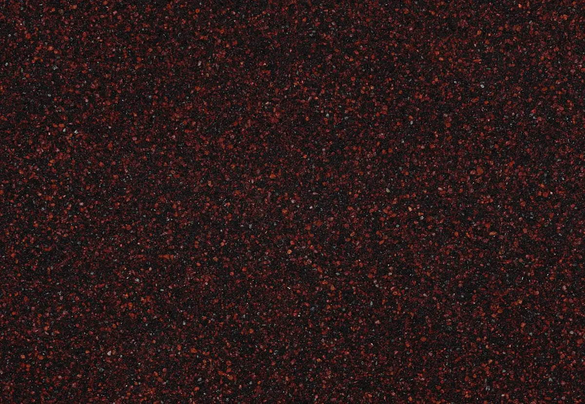 Granite Wilshire Red surface with deep burgundy background and scattered red speckles — premium stone countertops installed by Signature Stone Las Vegas