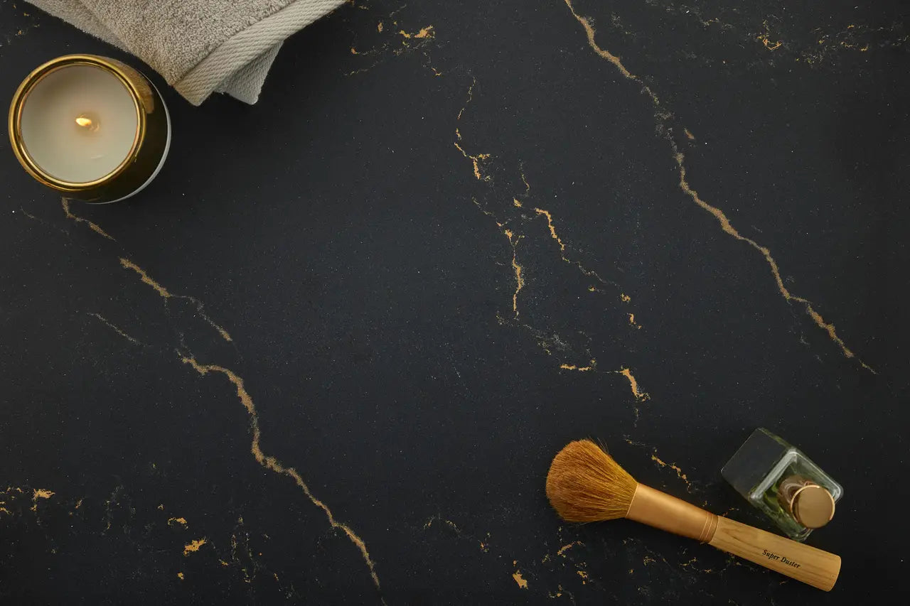 Dark marble surface with gold veining and makeup brush — custom countertops fabricated and installed by Signature Stone LV