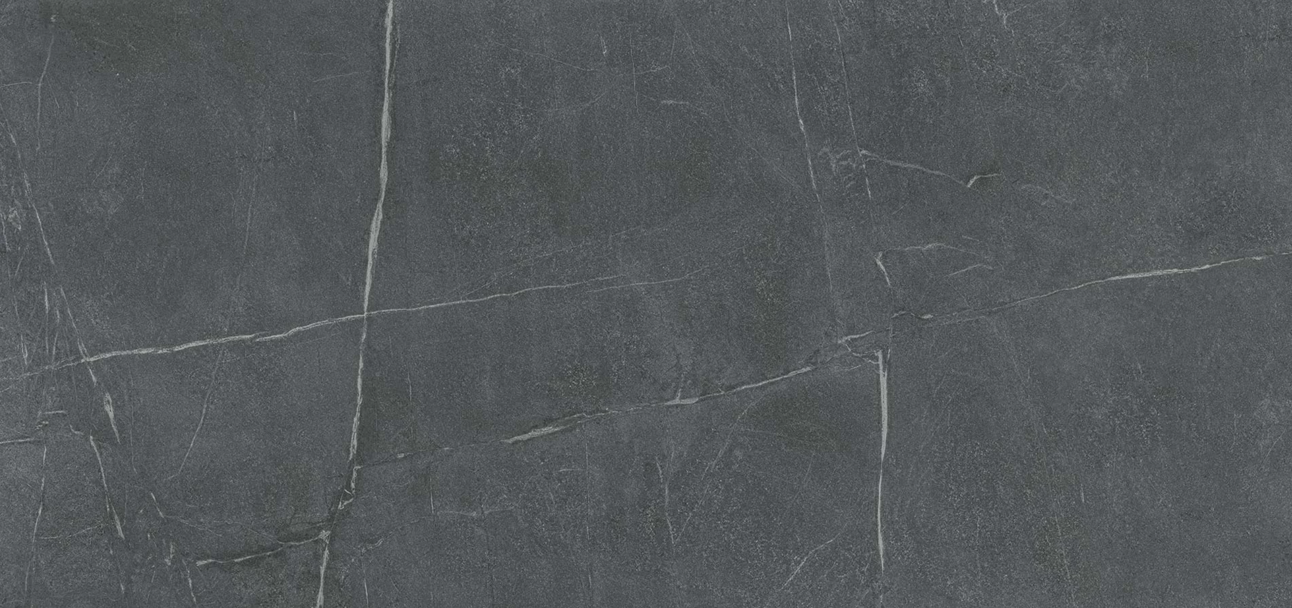 Soapstone Dark stone slab featuring natural gray and black tones with subtle white veining, ideal for custom countertops and kitchen or bathroom surfaces.
