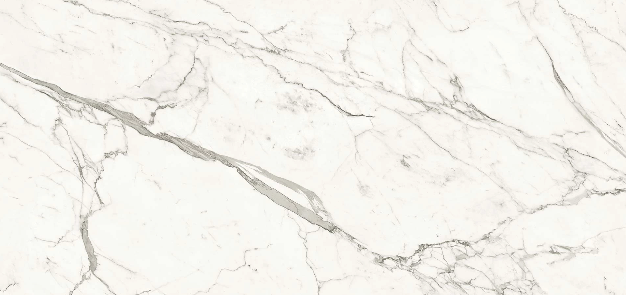 Statuario Supremo marble slab with elegant white background and flowing gray veining — custom countertops fabricated and installed by Signature Stone LV